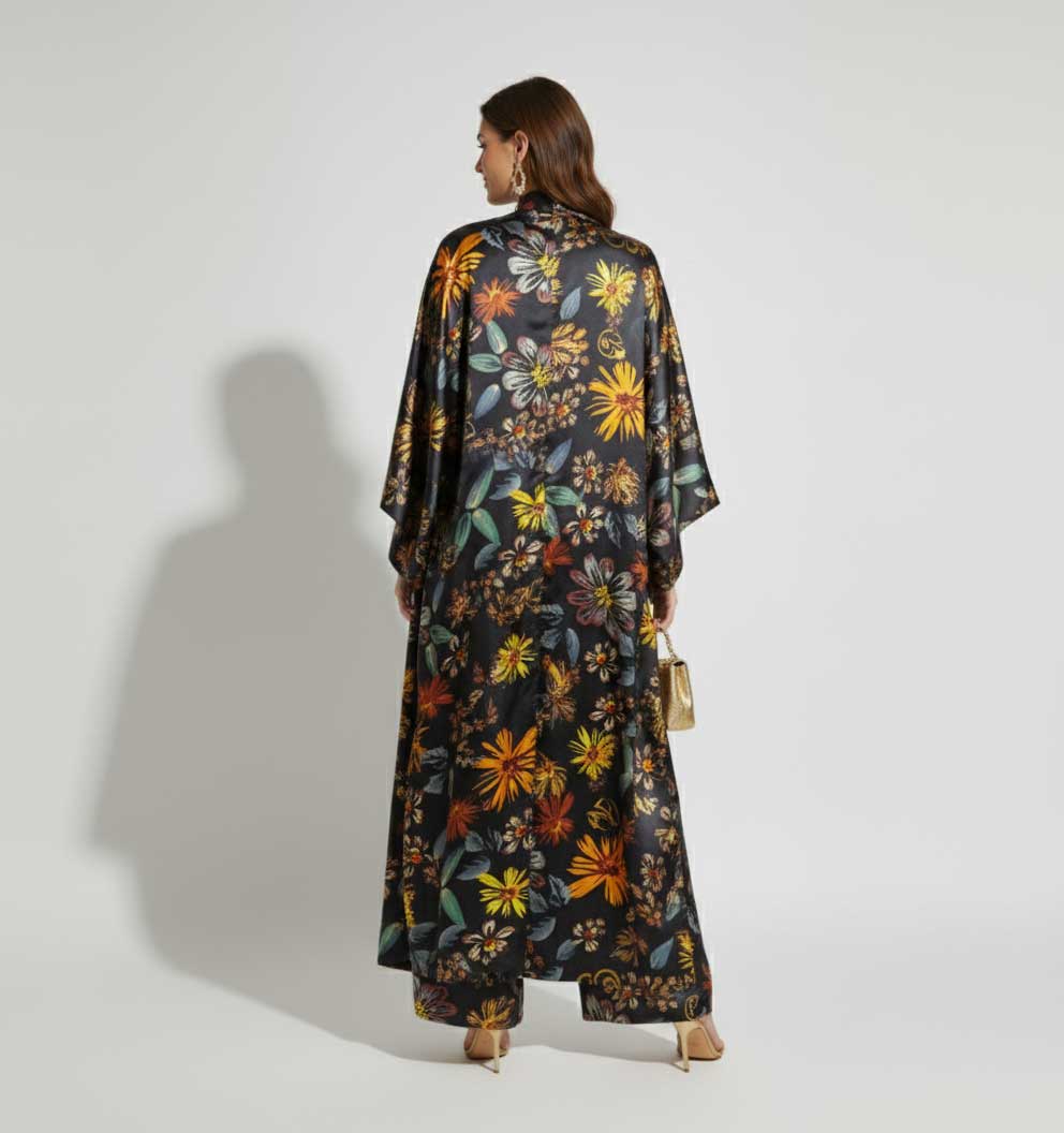 Woman wearing a long floral dress with a plain background