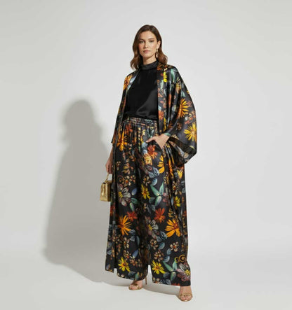 Woman wearing a floral kimono-style outfit on a plain background