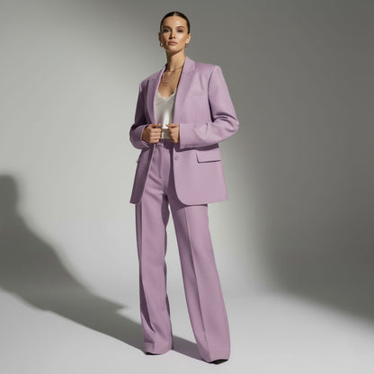 Woman wearing a lavender suit against a gray background